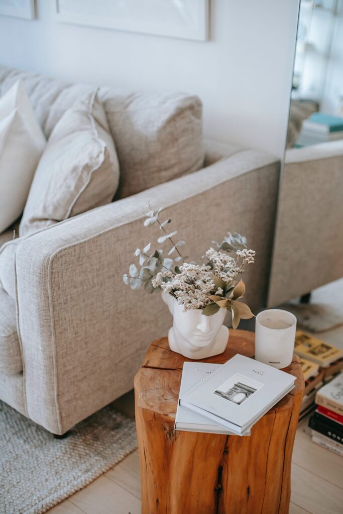 Living room interior with sofa, side table, and floral arrangement